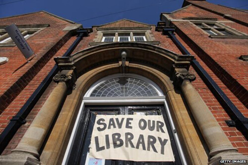 Save our Libraries banner hanging over the entrance of a library image